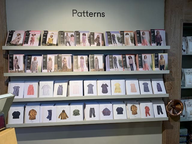 Display of dressmaking patterns on shelving inside Liberty's of London.