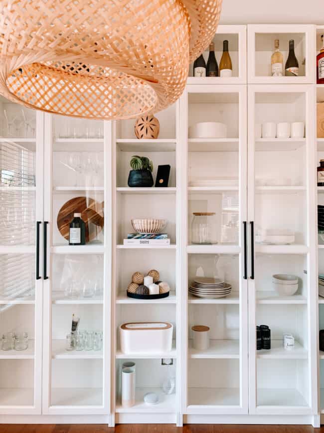 White fitted shelving with glass doors.