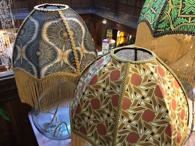 2 lamps with decorative lampshades inside Liberty's of London.