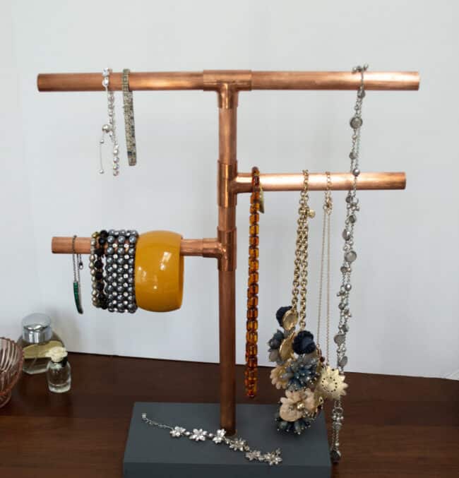Copper pipe jewelry stand.