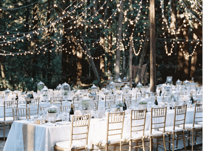 Tables set with string lights above outside.