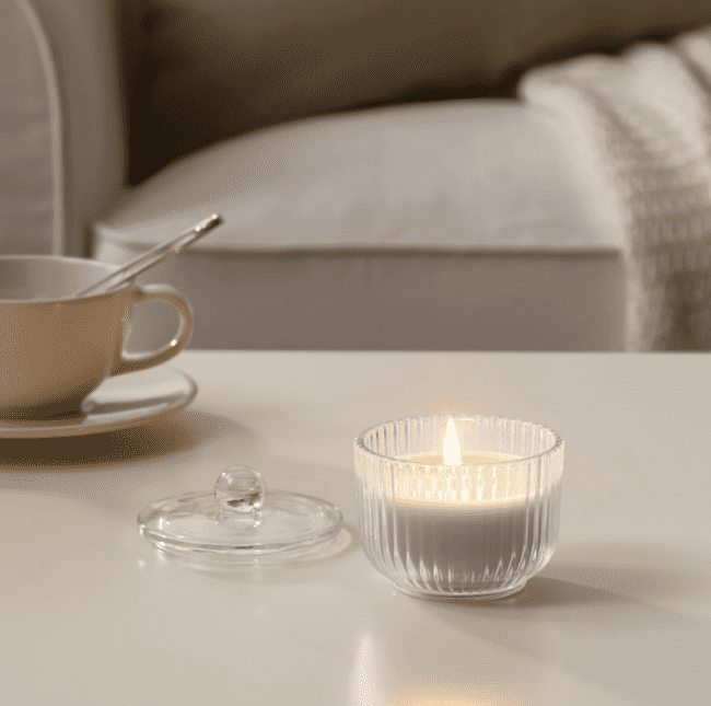 Glass jar with white candle