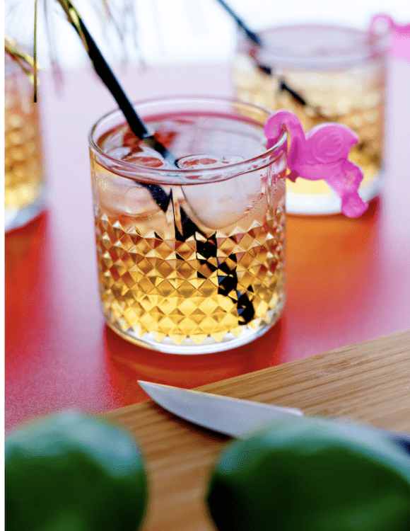 Whiskey glass with straw.
