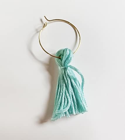 Blue tassel on gold hoop.