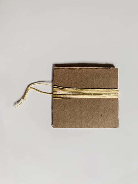 Cardboard with thread wrapped around.