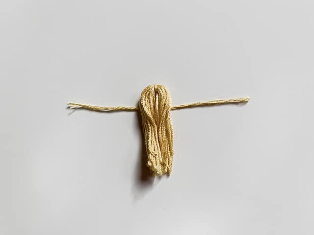 Yellow thread tassel tied.