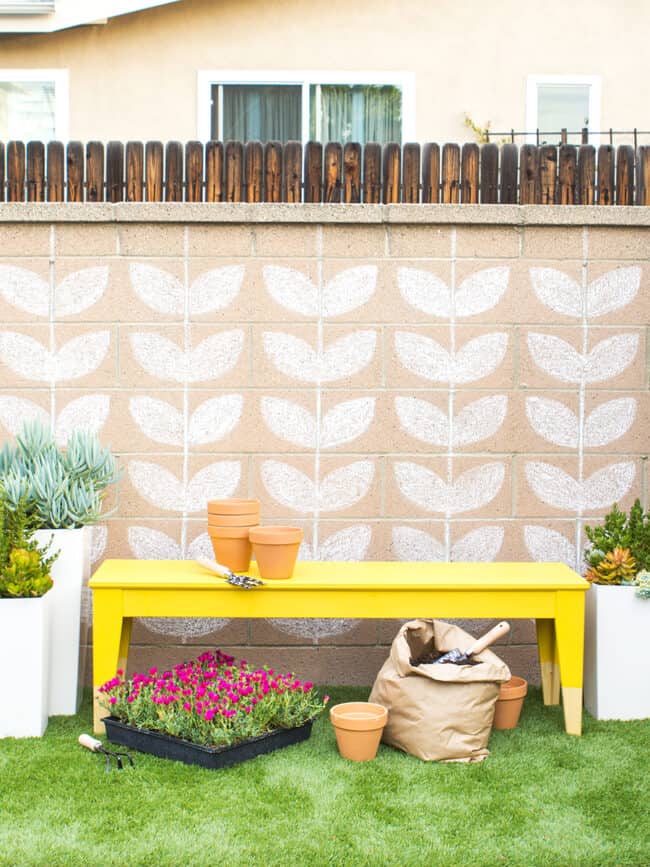 Bright yellow painted outdoor bench.