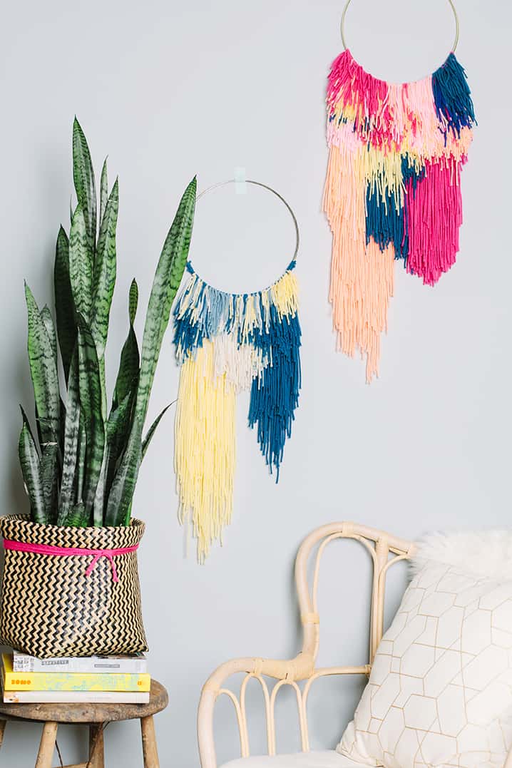 Wall weaving made of embroidery hoops and colored yarn.