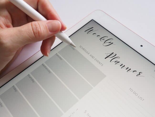 Woman writing on ipad digital planner with Apple Pencil